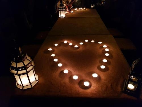 a heart drawn on a table with lights at Khadija Desert Camp in Merzouga
