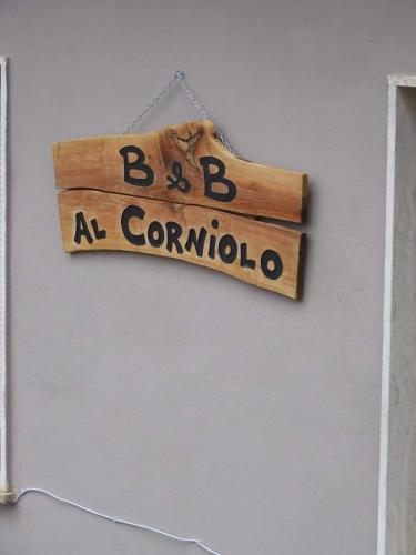a sign that says bc a corona hanging on a wall at AL CORNIOLO in Zerba