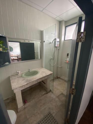a bathroom with a sink and a shower at Freedom8 in Khlong San