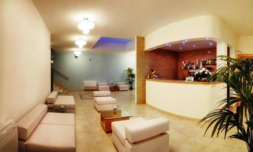 a lobby with couches and a bar in a building at Hotel Ristorante Il Vascello in Costa Rei