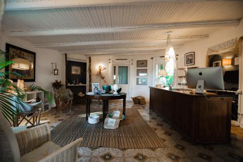 a living room with a table and a computer in it at Giardino dell'impossibile di Antonino Campo in Favignana