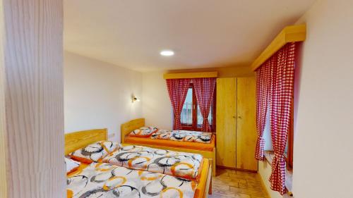 a bedroom with two beds and two windows at hiša Margit, Rateče 150 in Rateče