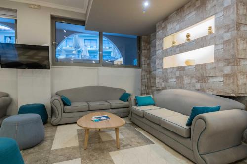 un soggiorno con 2 divani e un tavolo di Karras Grande Resort a Tsilivi