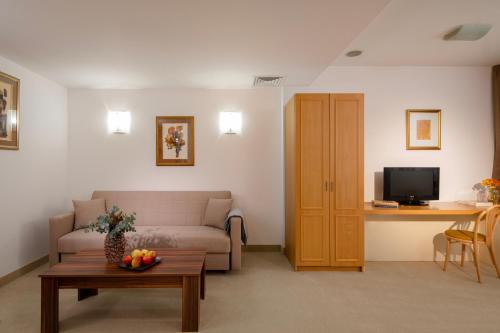 a living room with a couch and a table at Arte Sofia Hotel in Sofia