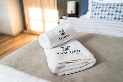 a couple of towels sitting on top of a bed at Penzion Monner in Mikulov