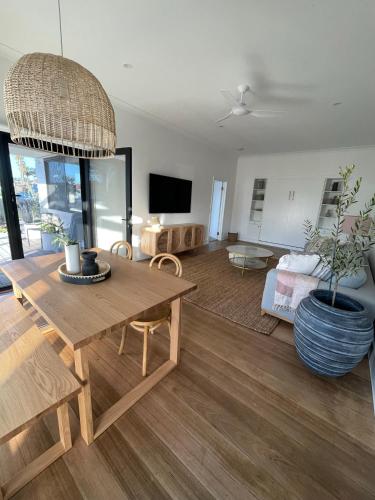 a living room with a table and a couch at Skipper’s Lakes Entrance *Waterfront* in Lakes Entrance