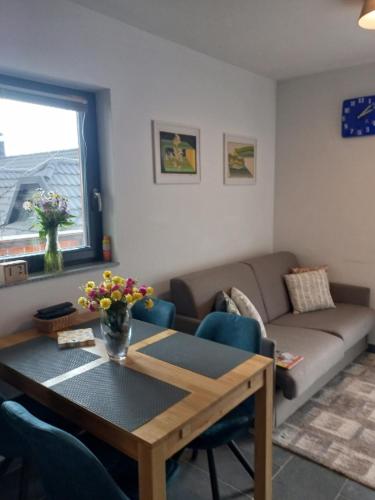 a living room with a table and a couch at Primorka Golte in Mozirje