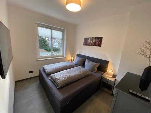 a bedroom with a bed and a window at Ferienhaus Deluxe in Halle an der Saale