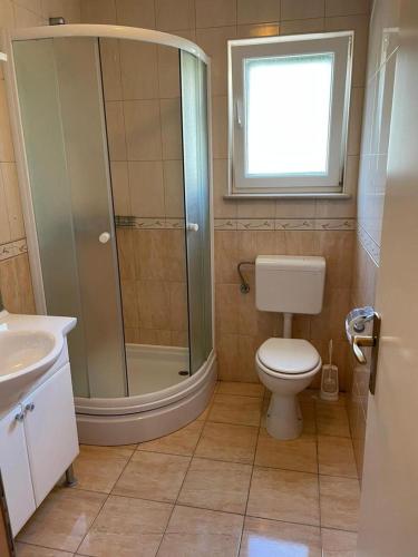 a bathroom with a shower and a toilet and a sink at Apartment Aurelia in Bol