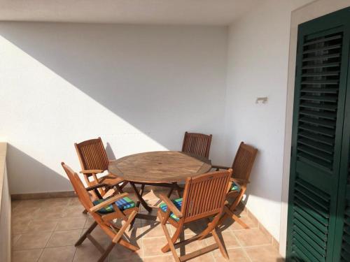 a wooden table and chairs in a room at Apartment Aurelia in Bol