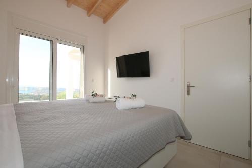 Ένα ή περισσότερα κρεβάτια σε δωμάτιο στο Sunset Sea View Villa 10
