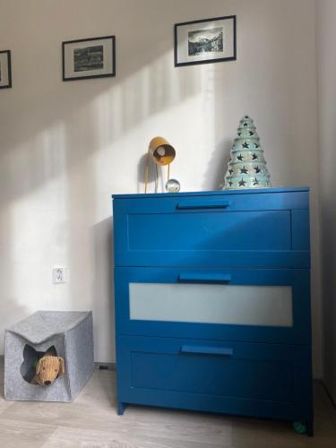 a blue dresser with a christmas tree on top of it at Slunný byt v Jizerských horách 5 postelí in Tanvald