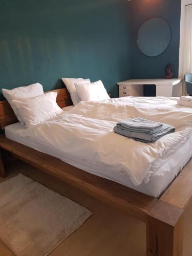 a large bed with white sheets and pillows on it at Appartement Randogne in Crans-Montana