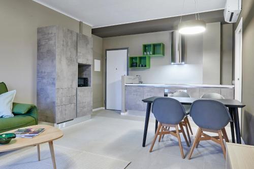 a kitchen and living room with a table and chairs at GREEN RIBBON in Milan