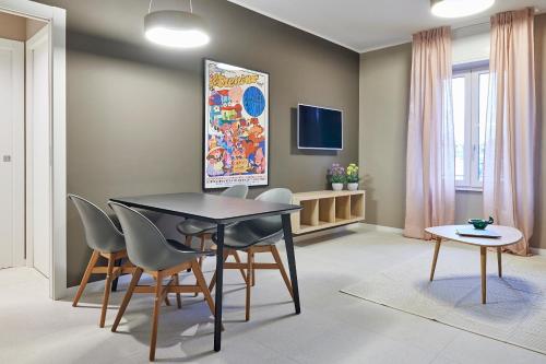 a dining room with a table and chairs at GREEN RIBBON in Milan