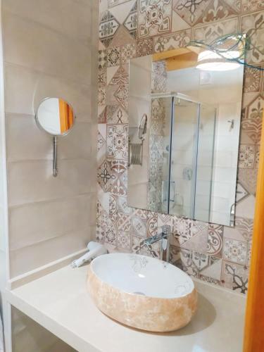 a bathroom with a sink and a mirror at CASA RURAL LA TORRITA in Acebo