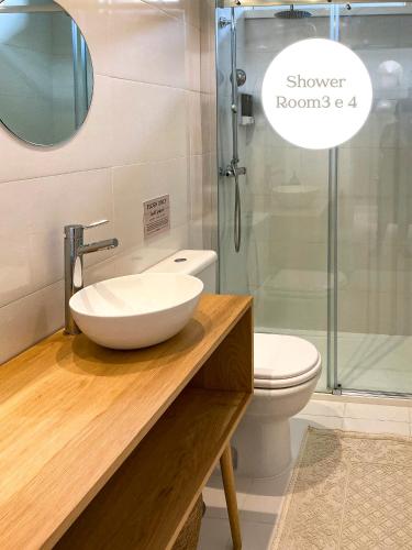 a bathroom with a sink and a shower room at Casa dos Pinheiros 109 - Private Villa with pool & heated SPA in Porto