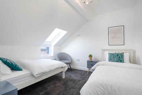 a bedroom with two beds and a window at Central Avenue Apartment in Belfast