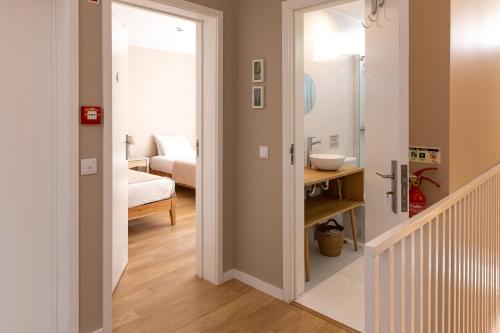 a hallway with a door leading to a bathroom at Casa dos Pinheiros 109 - Private Villa with pool & heated SPA in Porto