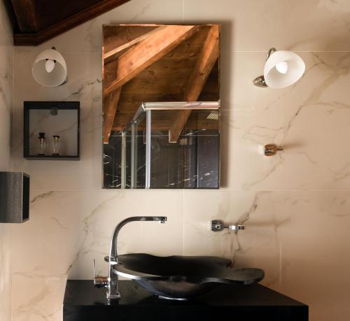 a bathroom with a sink and a mirror at Geroulios Kastro, a Grand Estate, By ThinkVilla in Vatoudhiáris