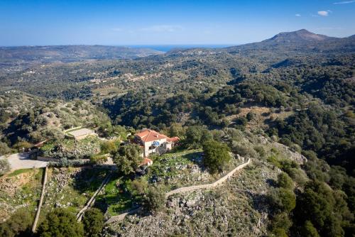 an aerial view of a house in the hills at Geroulios Kastro I & II, a Grand Estate, By ThinkVilla in Vatoudhiáris