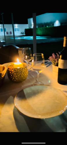 a table with glasses of wine and a candle at Blue Sky Transalpina in Săsciori