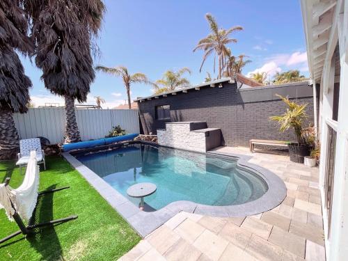 a swimming pool in the backyard of a house at Luxe Family Retreat! Pool, Sauna, Playground, Netflix, Disney Plus in Geraldton