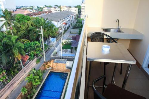 a balcony with a swimming pool and a sink at Sky Villa Hua Hin Guesthouse - Adults-Only in Hua Hin