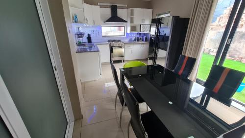 a kitchen with a table and a counter top at ARCHITECTS VIEW - EXECUTIVE SUITE in Durban