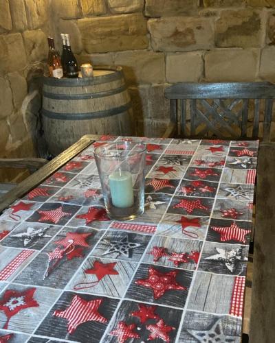 a table with a quilt on it with a candle on it at Roubenka Doubravice in Hrubá Skála