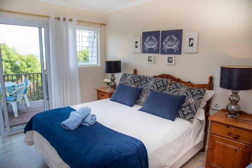 a bedroom with a bed with a blue towel on it at Rothesay in Knysna