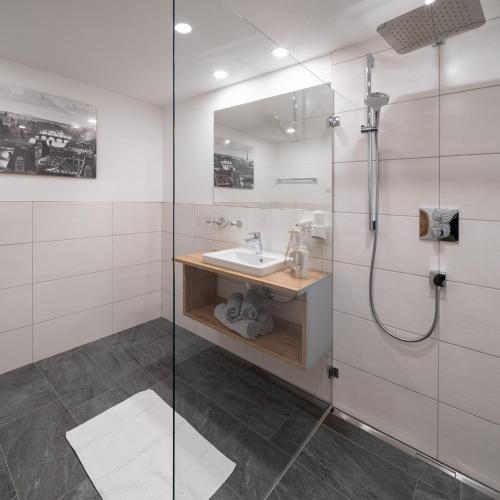a bathroom with a sink and a shower at Appartement Ferienhof Ortnergut in Eben im Pongau