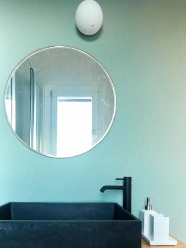 a bathroom with a black sink and a mirror at Villa Rocce Bianche in Favignana