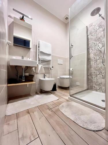 a white bathroom with a sink and a shower at Casa Nanà in Florence
