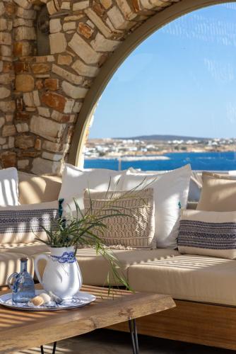 a living room with a couch and a table at Amalgam Homes Paros in Ambelas