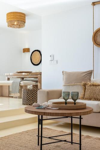 a living room with a couch and a coffee table at Amalgam Homes Paros in Ambelas