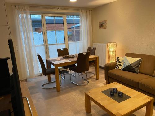 a living room with a table and a couch at Ferienwohnung-Maxi in Borkum