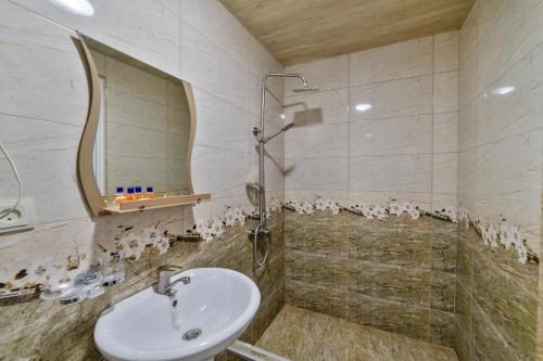 a bathroom with a sink and a shower at Zedazeni Hotel in Mtskheta
