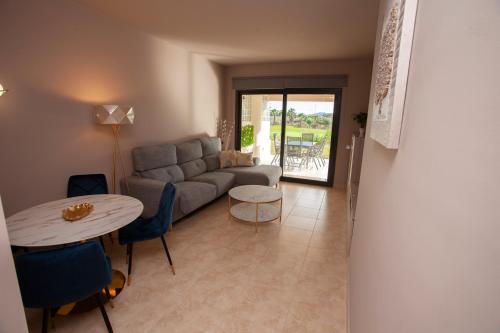 a living room with a couch and a table at Vera-Mojácar Valle del Este Resort Golf & SPA in Vera