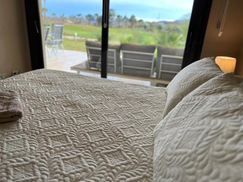 a bedroom with a bed with a view of a patio at Vera-Mojácar Valle del Este Resort Golf & SPA in Vera