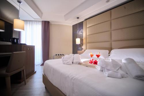 PARK HOTEL LE DUNE DI GIOVINOにあるベッド