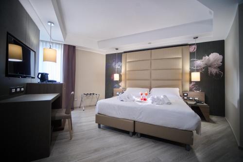 PARK HOTEL LE DUNE DI GIOVINOにあるベッド