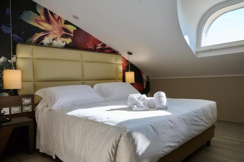 PARK HOTEL LE DUNE DI GIOVINOにあるベッド