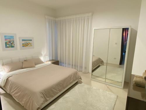 a bedroom with a large bed and a mirror at Gozo Dwejra Views in San Lawrenz