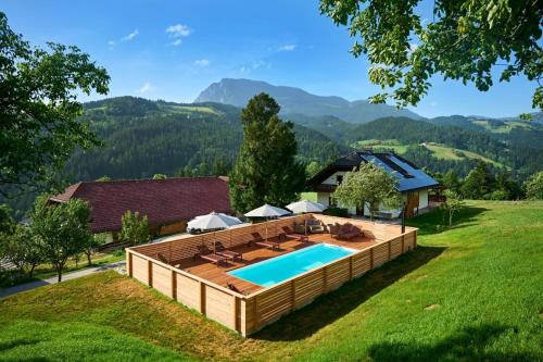 an overhead view of a pool with a deck and a house at Domačija Metul in Luče