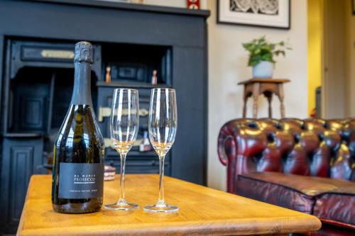 a bottle of wine sitting on a table with two wine glasses at Apartment 4 - The Kings in York