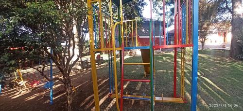 a playground with colorful play equipment in a park at Pousada Vila Margarida in Chapada dos Guimarães
