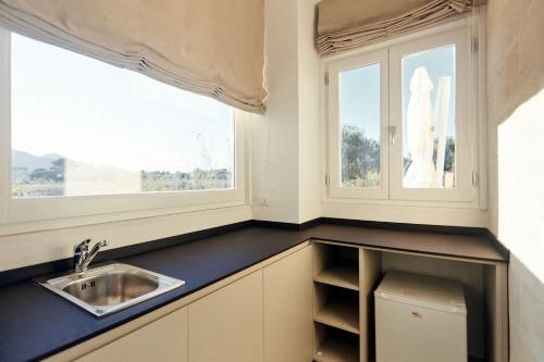 a kitchen with a sink and a window at Villa Rocce Bianche in Favignana