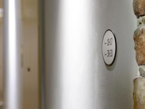 a clock on the side of a wall at Rex Petit in Stockholm