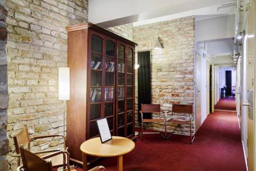 a room with a brick wall and a table and chairs at Rex Petit in Stockholm